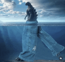 a statue of a monster is standing in the ocean