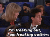 a man and a woman are sitting on an airplane and the man says i 'm freaking out