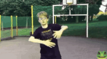 a boy is dancing in front of a basketball hoop .