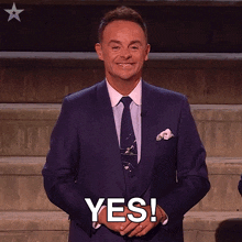 a man in a suit and tie says " yes "