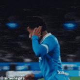 a soccer player wearing a blue jersey that says joma on it