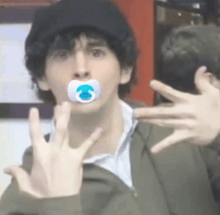 a young man with a pacifier in his mouth