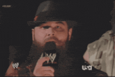 a man speaking into a microphone with the words " i got the whole damn world in my hands "