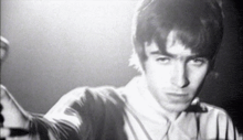 a black and white photo of a man 's face and neck