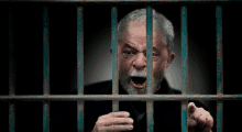 a man behind bars with his mouth open