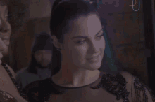 a woman in a black dress is looking down at something