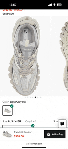 a phone screen shows a pair of grey balenciaga sneakers