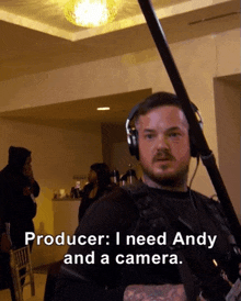 a man wearing headphones and holding a camera with the caption producer i need andy and a camera