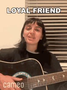 a woman is playing a guitar in front of a window with blinds and a caption that says loyal friend