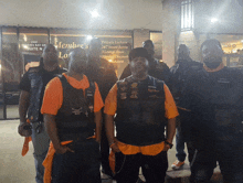 a group of men standing in front of a building that says member 's lo