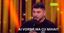 a man speaking into a microphone with ai vorbit ma cu mihai written on the bottom