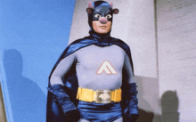 a man in a batman costume with the letter a on the chest