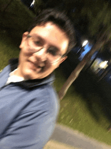 a blurry photo of a man wearing glasses