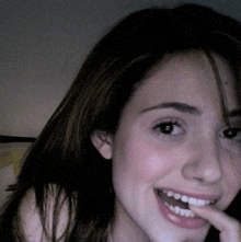 a close up of a woman 's face with her mouth open