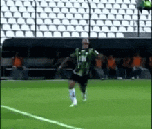 a soccer player wearing a green shirt with the number 17 on it