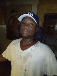 a man wearing a white shirt and a blue hat with the letters fr on it