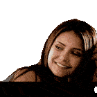 a woman with long brown hair is smiling with her hand on her head
