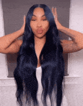 a woman with long dark blue hair and a white dress