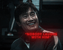 a man is laughing with the words `` nobody laughs with him '' written above him .