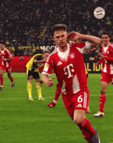 a soccer player wearing a red and white t-mobile jersey
