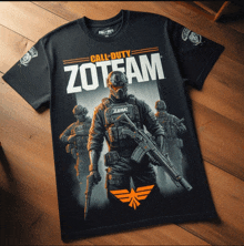 a black call of duty zoteam t-shirt is laying on a wooden floor