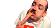 a man with a mustache is eating a carrot .