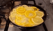 lemon slices are cooking in a pan on a stove .