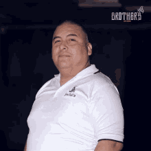 a man wearing a white shirt with brothers on it