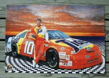 a man standing next to a race car that has the number 10 on it