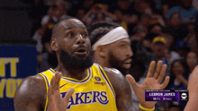 a basketball player wearing a lakers jersey is making a funny face