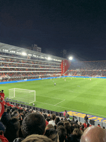 a crowd of people watching a soccer game in a stadium with a banner that says ' allianz ' on it