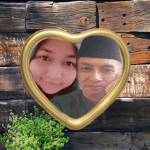 a heart shaped frame with a man and a woman in it