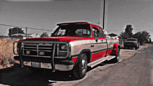 a red and white dodge truck with a license plate that says b-924440