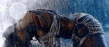 a woman in a bikini is bending over in the rain