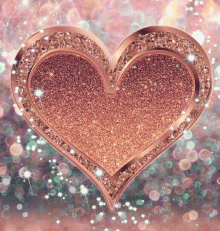 a heart made of glitter and rhinestones is surrounded by sparkles