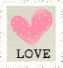 a pink heart with white polka dots and the word love below it