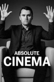 a man is sitting in a chair with his hands in the air .