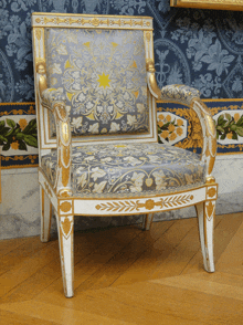 a chair with a blue and gold floral pattern