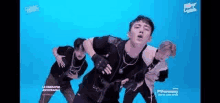 a group of men are dancing on a blue background .