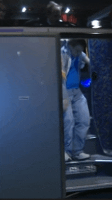 a man in a blue shirt and white pants is walking up stairs