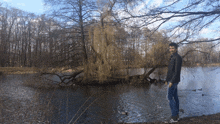 a man standing on the shore of a lake