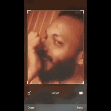 a man with a beard is being taken on a phone with the words reset done and send at the bottom