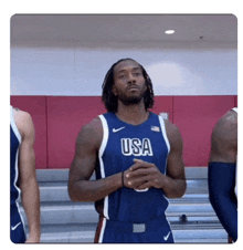 a basketball player wearing a blue usa jersey