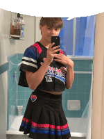 a boy in a cheerleader outfit takes a selfie with his phone