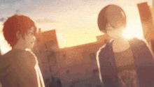 a couple of anime characters standing next to each other in front of a sunset .