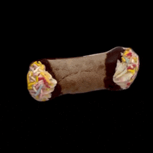 a cannoli with chocolate frosting and sprinkles on it