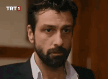 a close up of a man 's face with trt1 written on the bottom