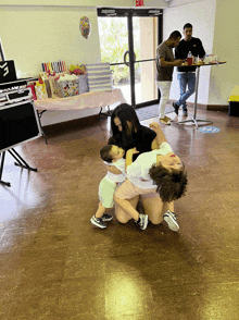 a woman holds a baby while another woman holds another child