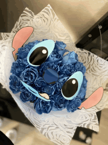 a bouquet of blue flowers with stitch 's face on it