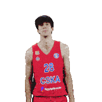 a man wearing a red cska jersey points up